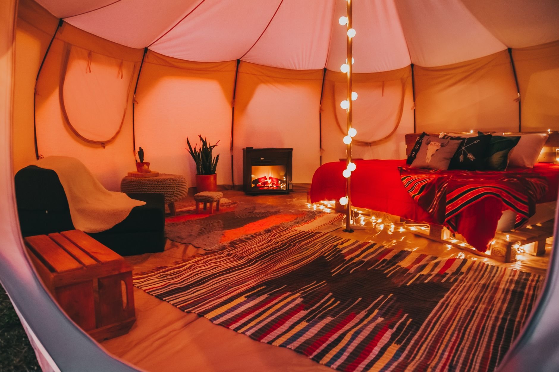 Warm and inviting safari tent interior with cosy lighting and plush décor.